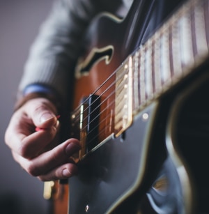 Strumming with guitar pick